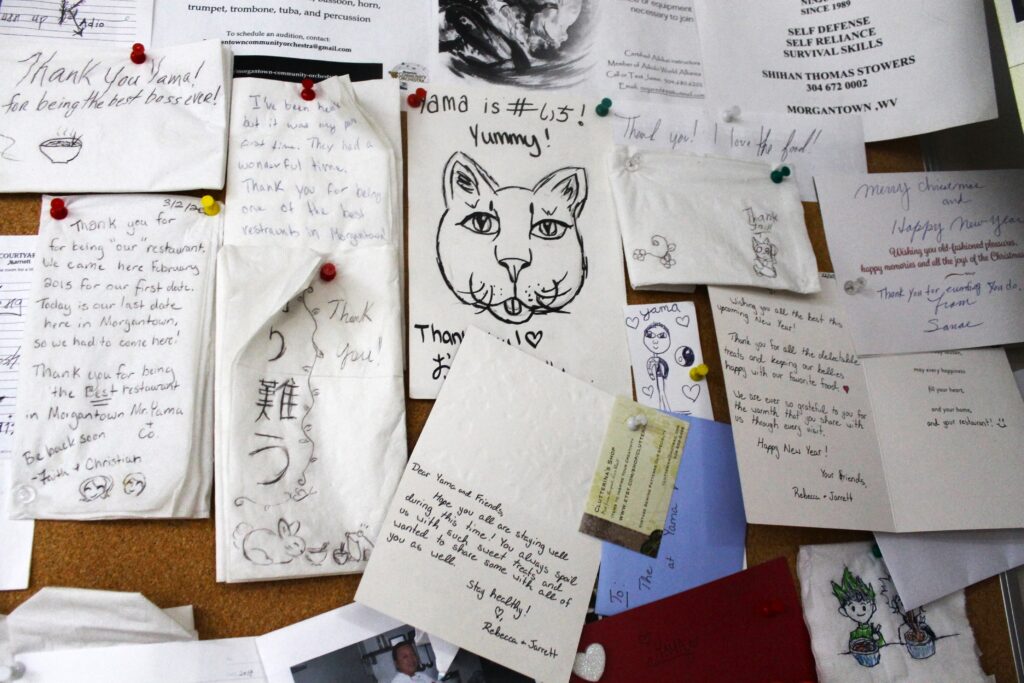 A corkboard is shown full of papers. Some are cards and others are drawings. All appear to be testimonials from satisfied customers.