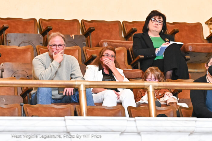 A family sits in the stands looking emotional.