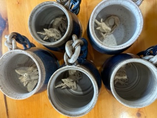 Five handmade mugs are shown. All feature unicorns inside the mugs.