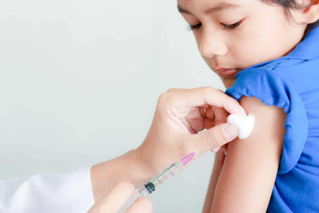 A child is seen receiving a vaccine.