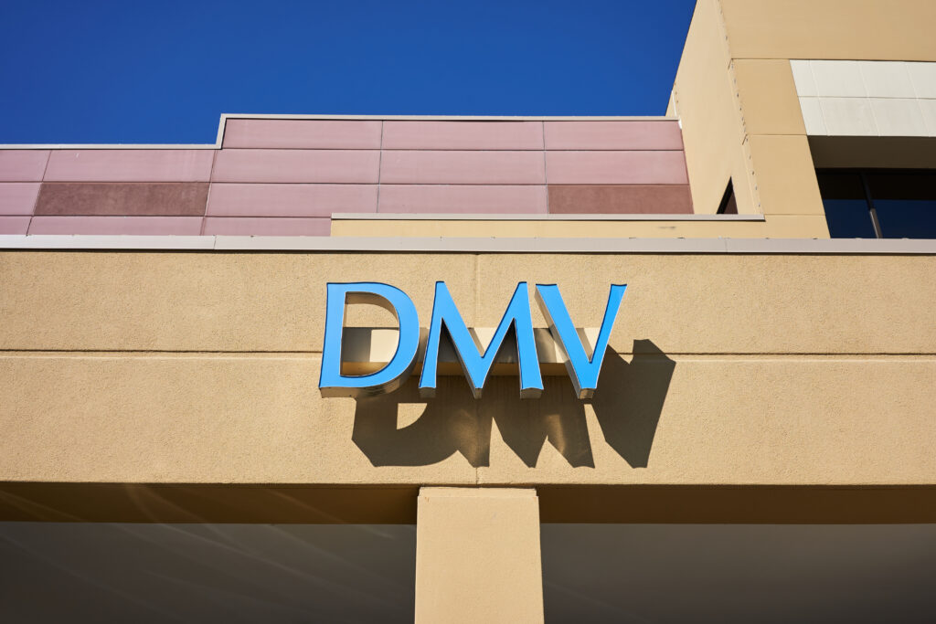 Signage on the front of a building that reads DMV.