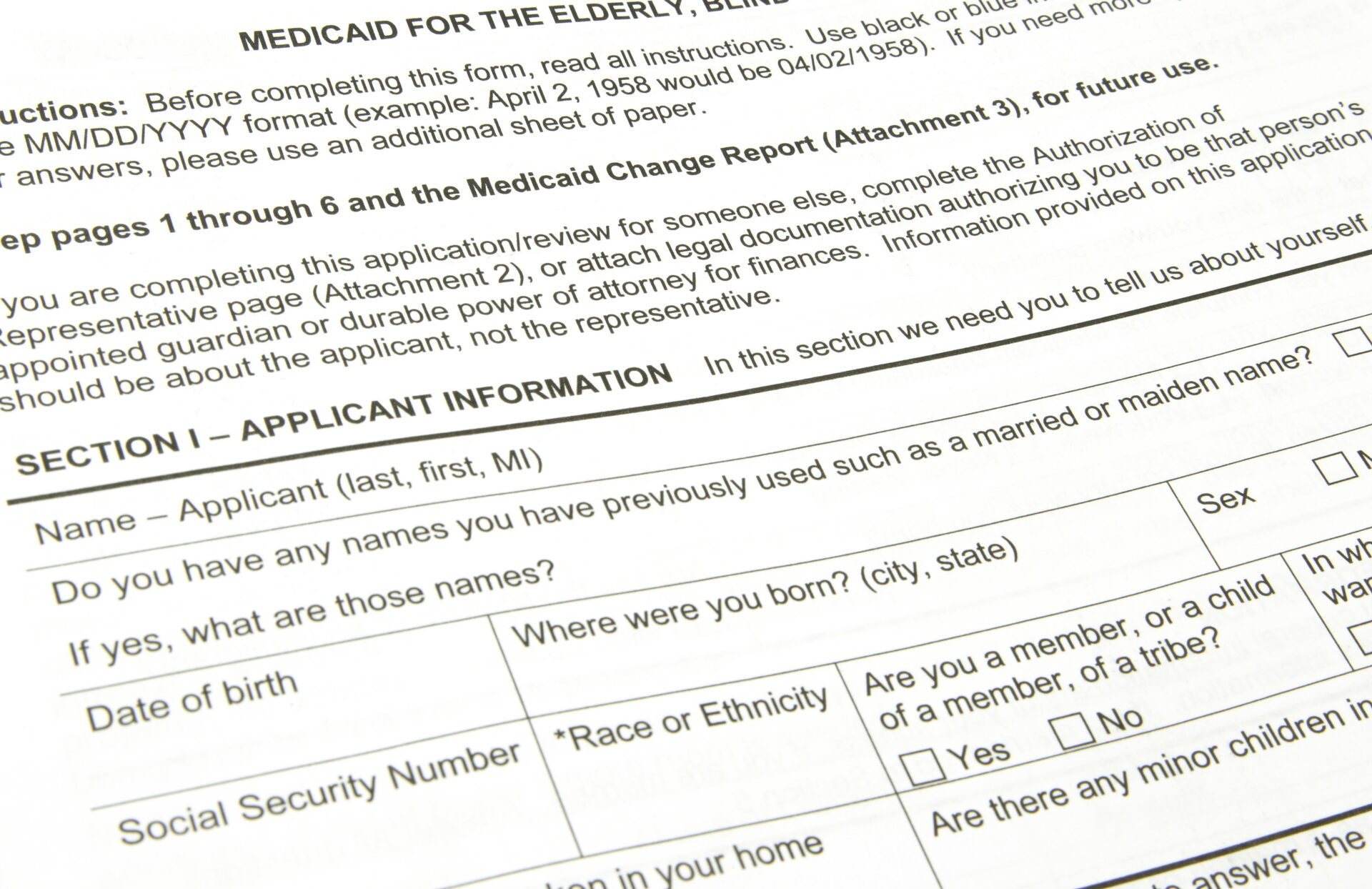 A Medicaid application waiting to be filled out. It is a piece of white printer paper with black printed words reading eligibility requirements.