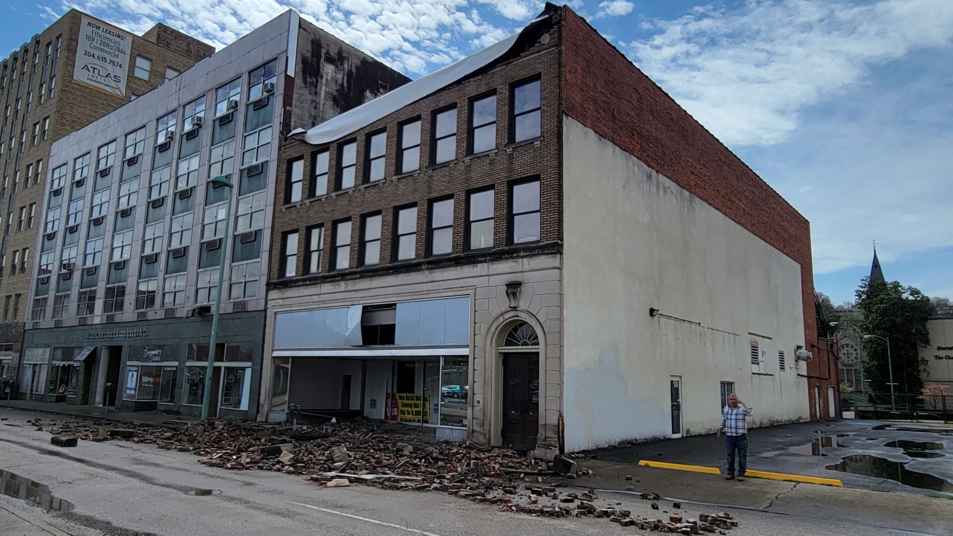 Crumbled bricks lie in the street in front of a damaged building in Charleston, West Virginia.