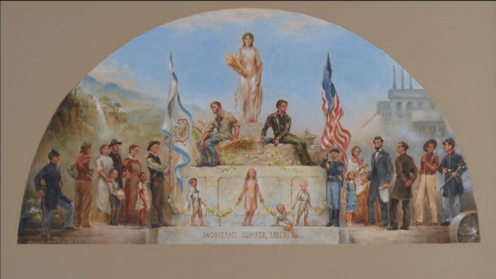 A mural is depicted of 23 individuals. Both male and female. On either side of a pillar are the American and WV flags. A woman holding wheat stands atop the pillar. On the bottom of the pillar reads the words, "Montani, Semper, Liberi."