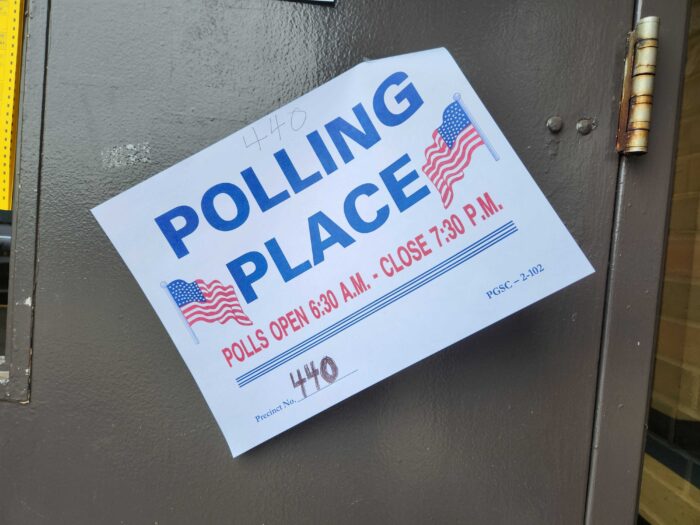A sign that reads, "Polling Place" is shown on a door.
