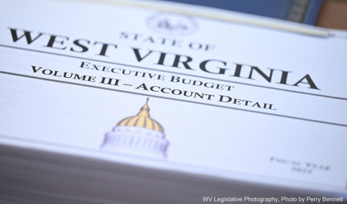 An unopened packet of papers with a cover that reads "State of West Virginia Executive Budget Volume III - Account Detail." On the bottom of the cover is an illustration of the West Virginia State Capitol.