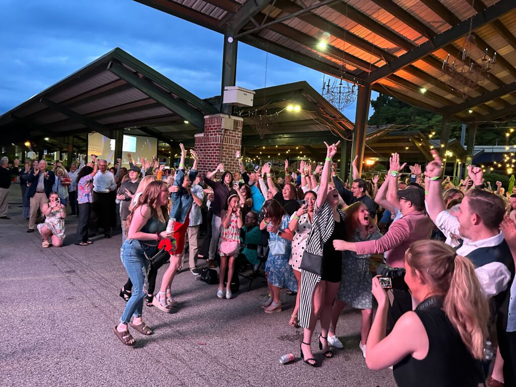 crowd of people jumping and celebrating