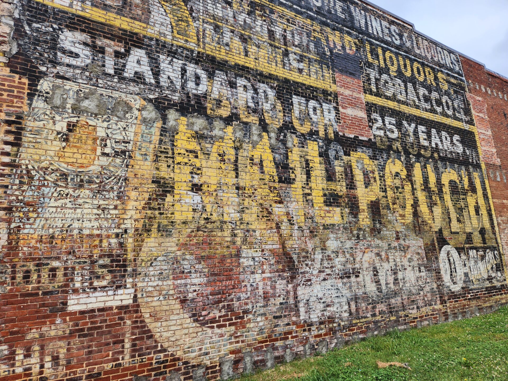 faded signs decorate a red brick building