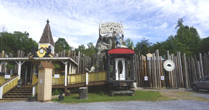 A statue of confederate soldier fights a giant reptile on the roof to the entrance of the tourist attraction, Dinosaur Kingdom, in Virginia.