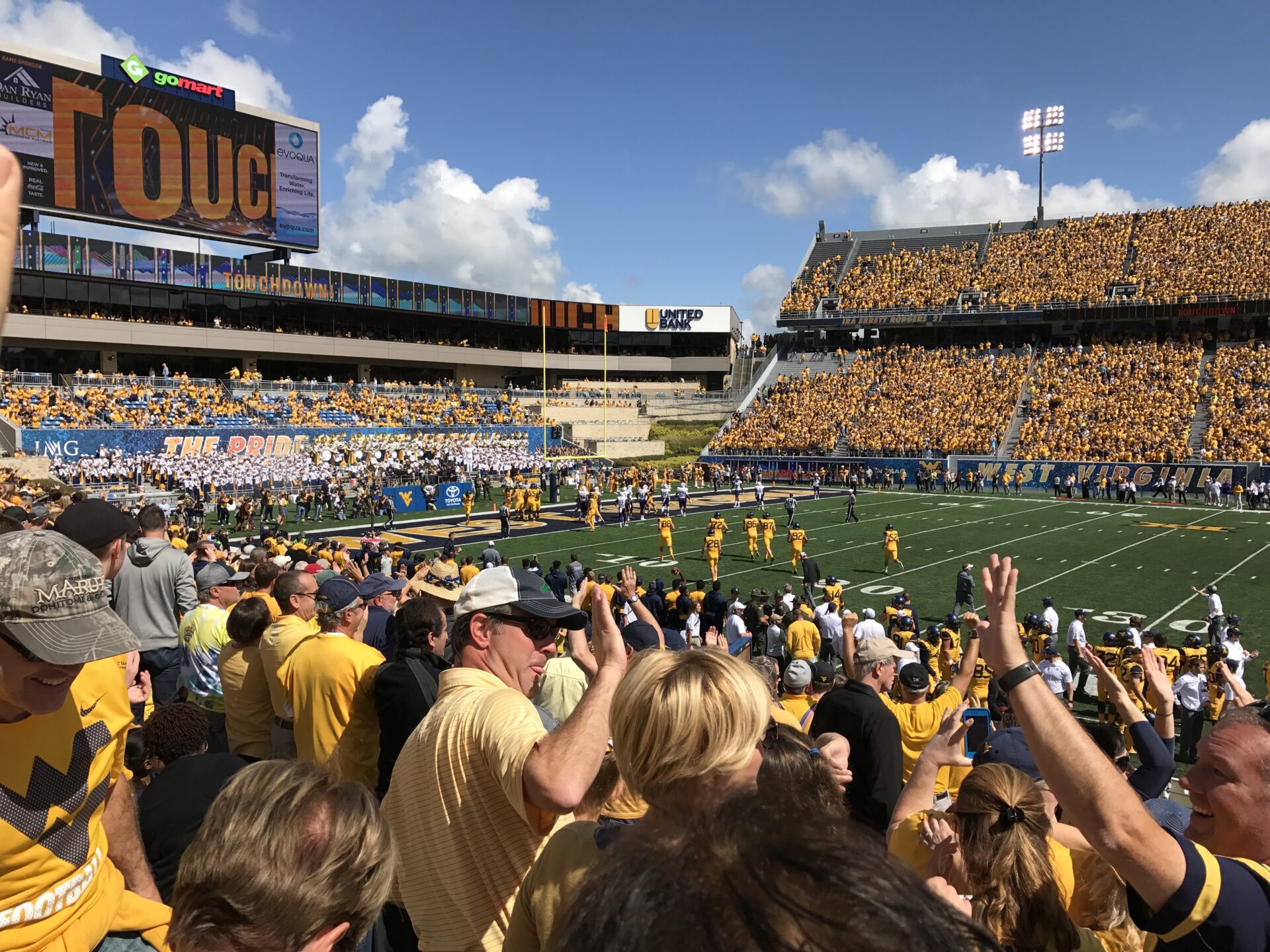 fans celebrate a touchdown at a football game