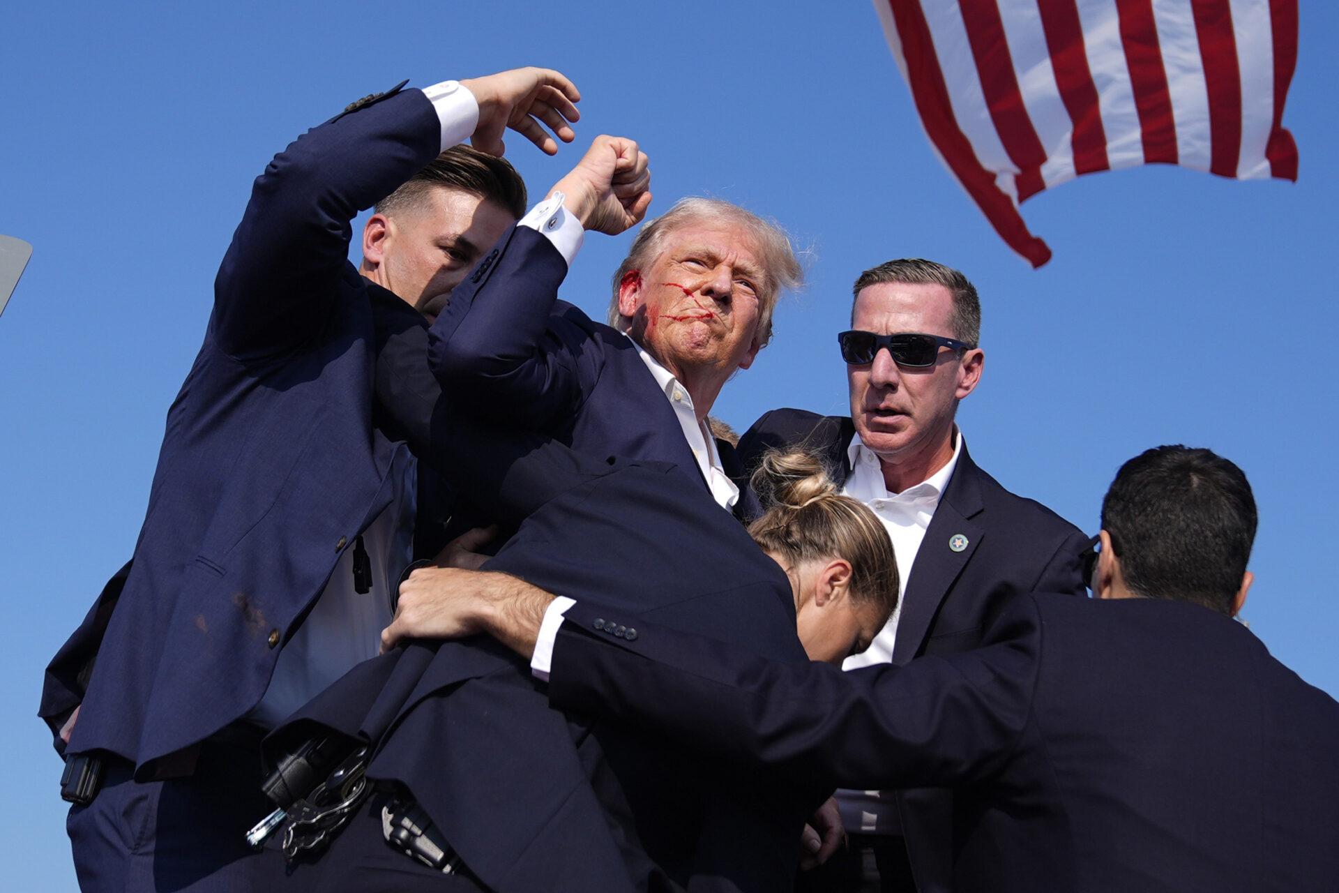 Trump Injured But ‘Fine’ After Apparent Assassination Attempt Leaves Rally-goer And Gunman Dead