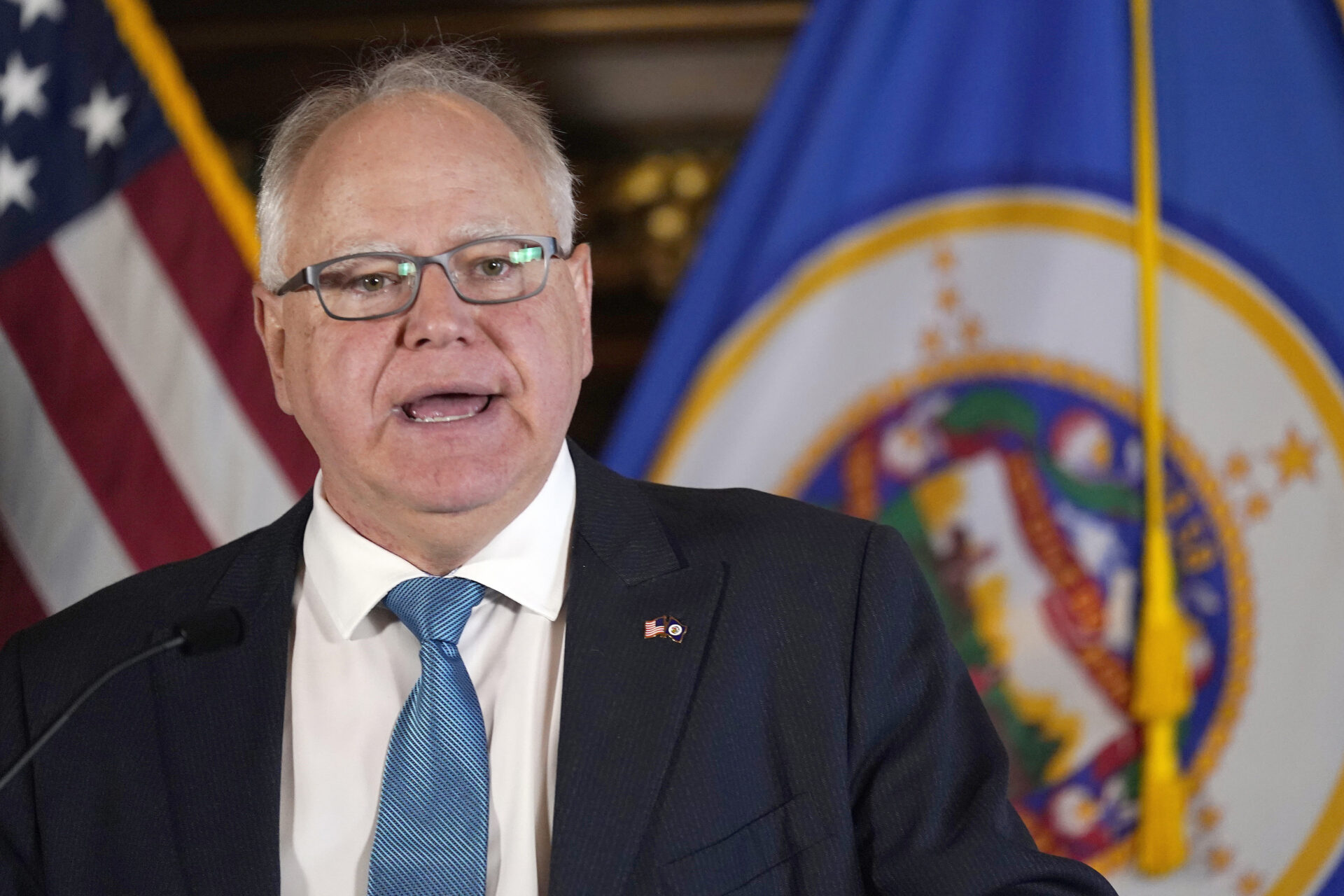 Man in dark suit and light blue tie