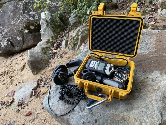 A yellow box filled with audio recording equipment.