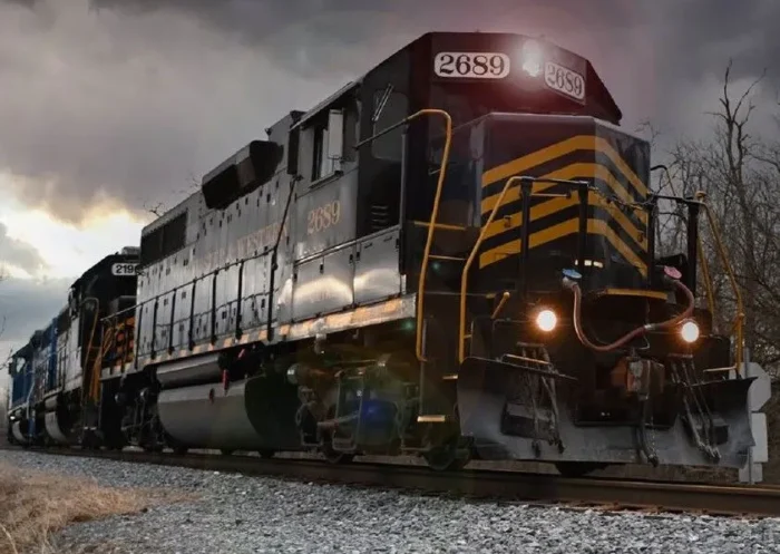 A dimly lit image of a locomotive under a dark sky.