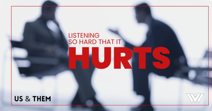 A graphic featuring two people talking while sitting across from each other. On the graphic, there are red letters that read, "Us & Them: Listening So Hard That It Hurts."