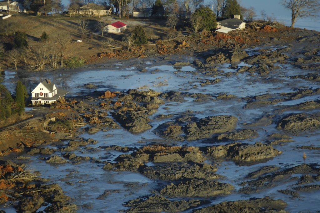 An aerial view of a countryside in East Tennessee submerged coal-ash slurry, which is a black sludge substance mixed with water.