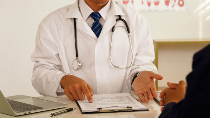 Patient having consultation with doctor or psychiatrist who working on diagnostic examination on men's health disease or mental illness in medical clinic or hospital mental health service center.