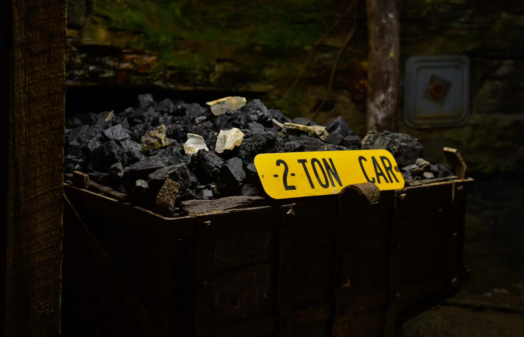 A cart full of coal is shown. A sign on the cart reads "2 TON CAR."