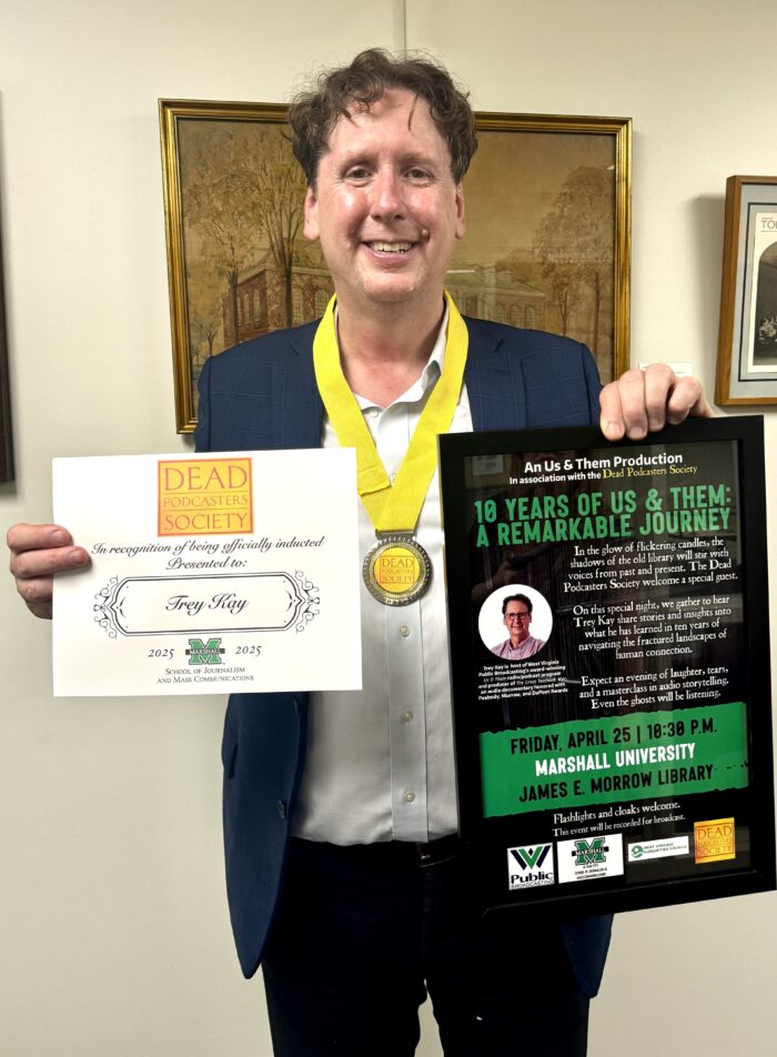 Trey Kay is seen smiling after becoming a member of the Dead Podcasters Society at Marshall University.