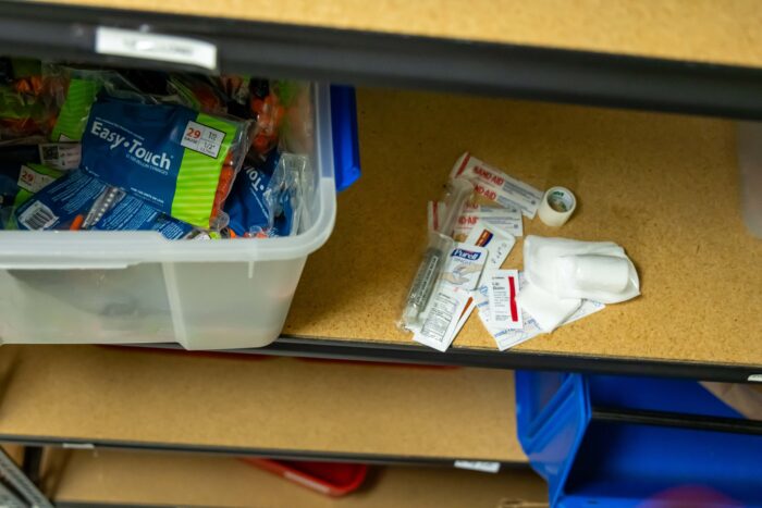 syringes on a shelf and bandages on a shelf
