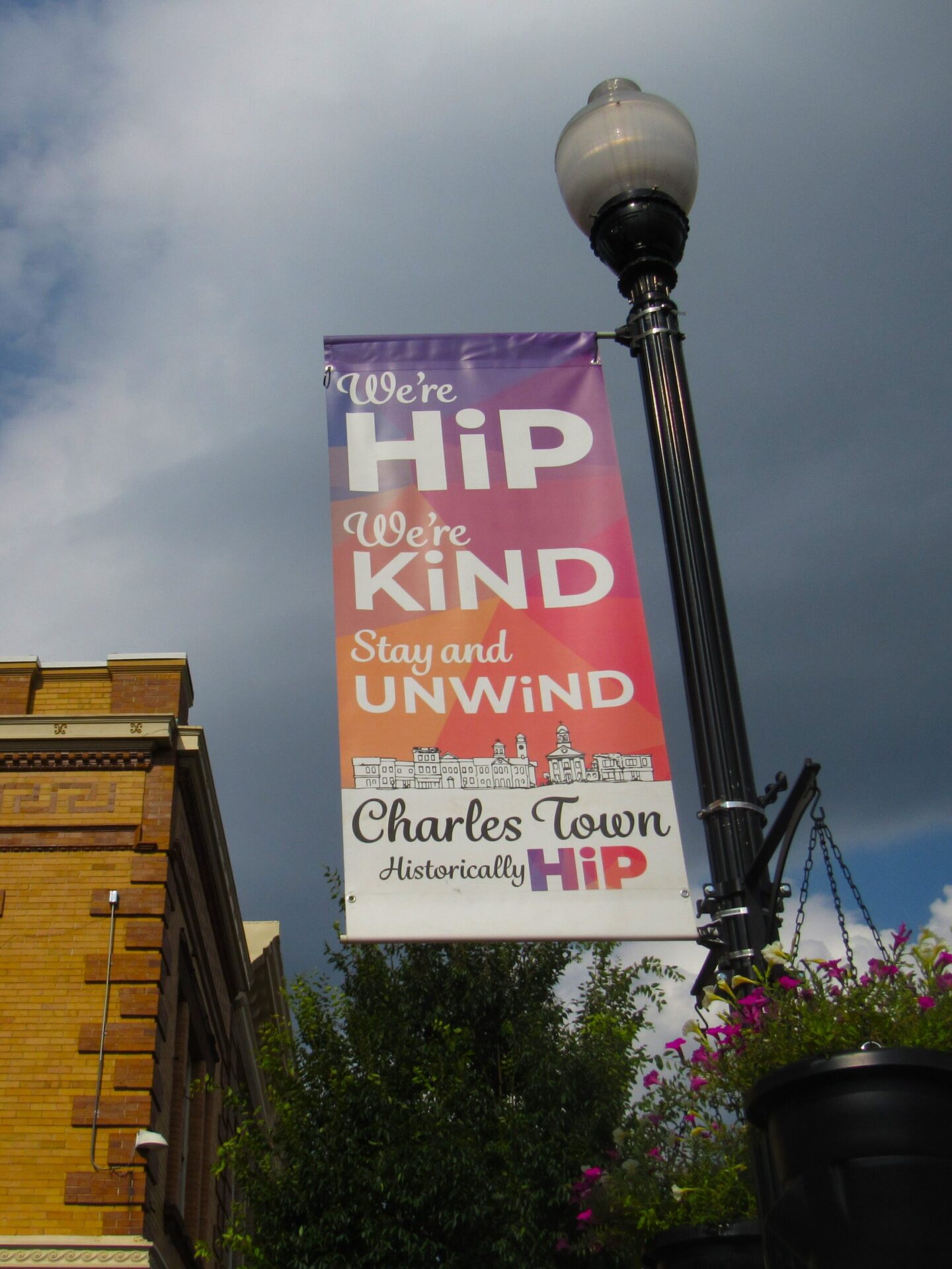 A sign on a street lamp post advertises Charles Town's historic downtown.