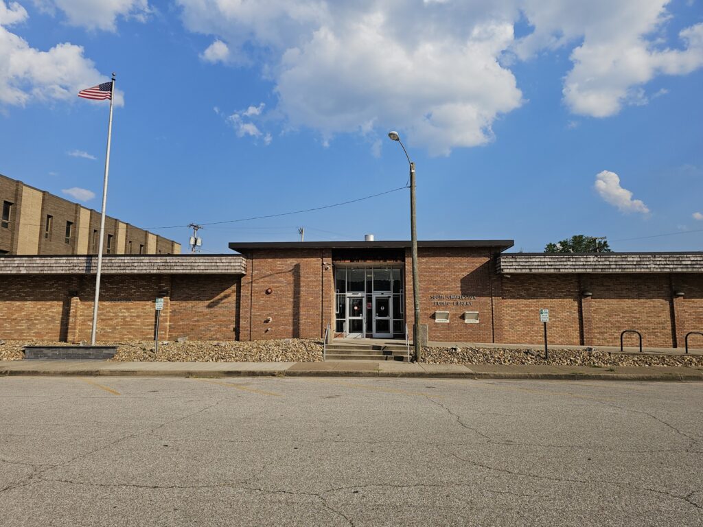 A long brick building displays text that reads "South Charleston Public Library."