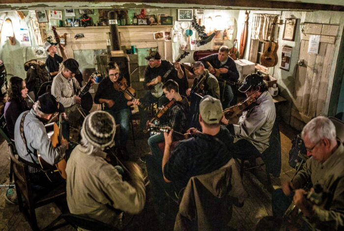 A room of people playing instruments.