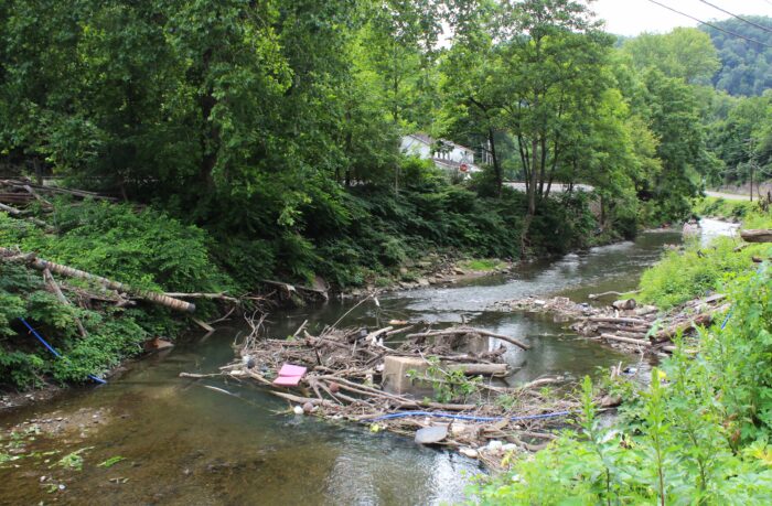 Debris and concrete footers stand in the middle of the Tug Fork River.