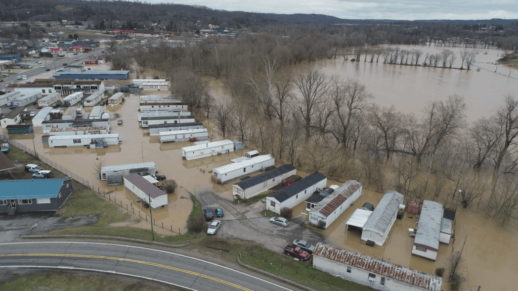 Aerial view of flooded residences, businesses and a river