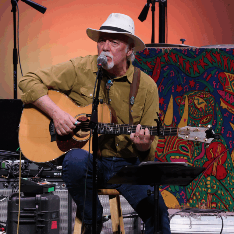 musician with hat and guitar