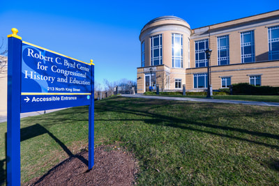 Outside the front of the Byrd Center on Shepherd University's campus. The sky is clear and blue.