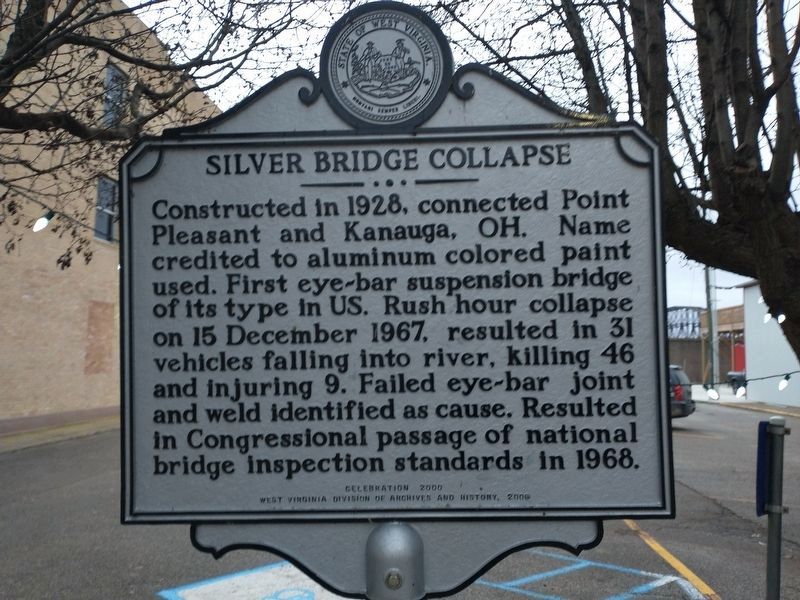 A white road sign giving details of the Silver Bridge collapse.