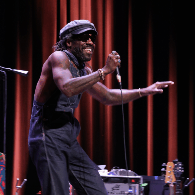 performing sings into mic