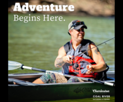 A man sits in a kayak on the river. He is smiling. Text on the graphic reads Adventure Begins Here. Charleston West Virginia Visitors Bureau, Coal River, Kayaking and Fishing.