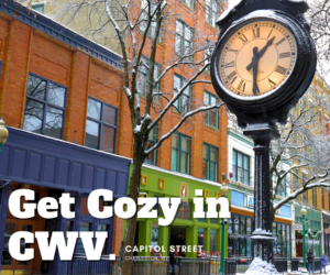 A photograph of Downtown Charleston. A brick building is seen and a large black clock on a post. Text on the graphic reads, "Get Cozy in CWV." Capitol Street.