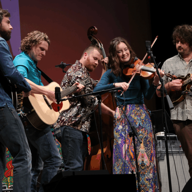 musicians play instruments on stage