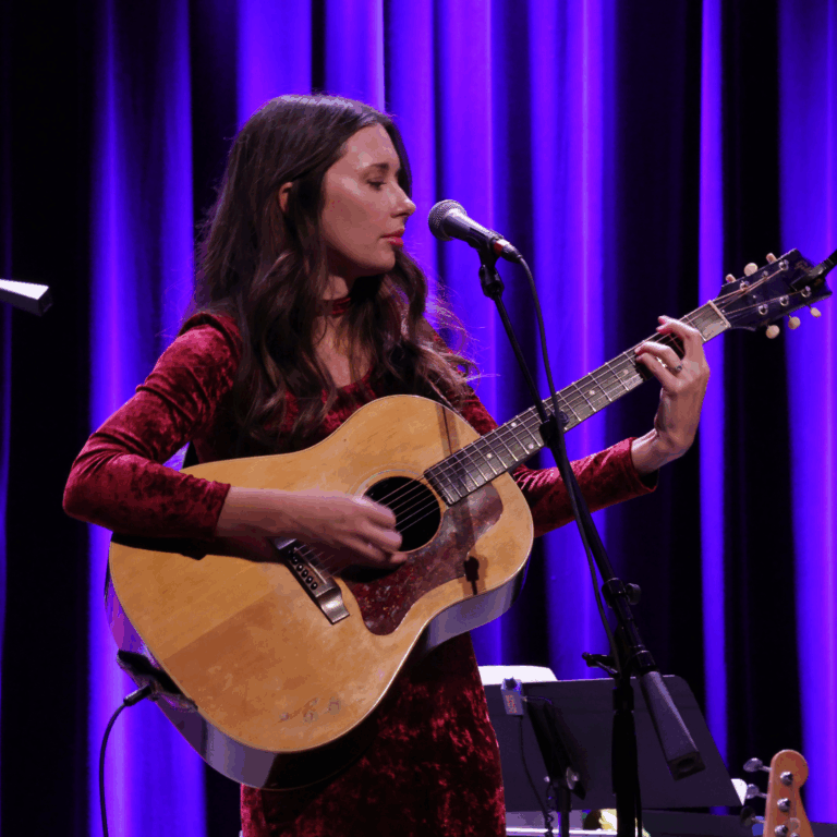 woman plays the guitar