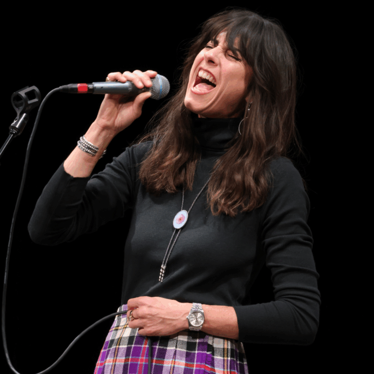 woman sings into microphone