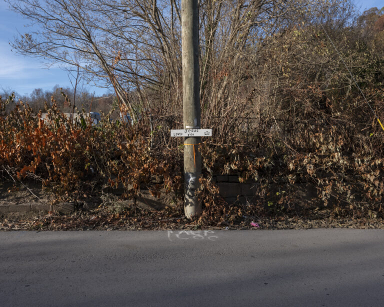 A faraway photograph of a sign on an power pole.
