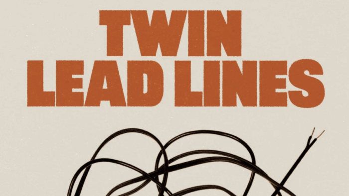 The cover of a book titled, "Twin Lead Lines." There is a wire below the title.