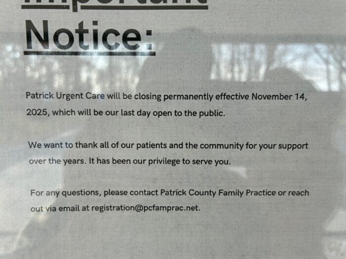 A sign on a glass door. The sign says the urgent care is closing.