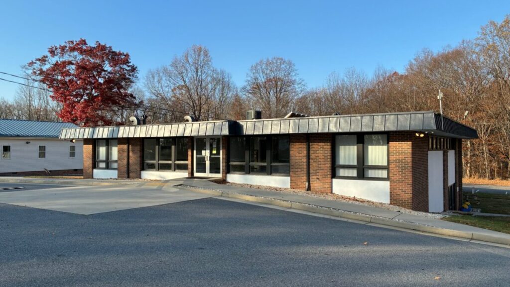 The outside of a building. It is a sunny day.