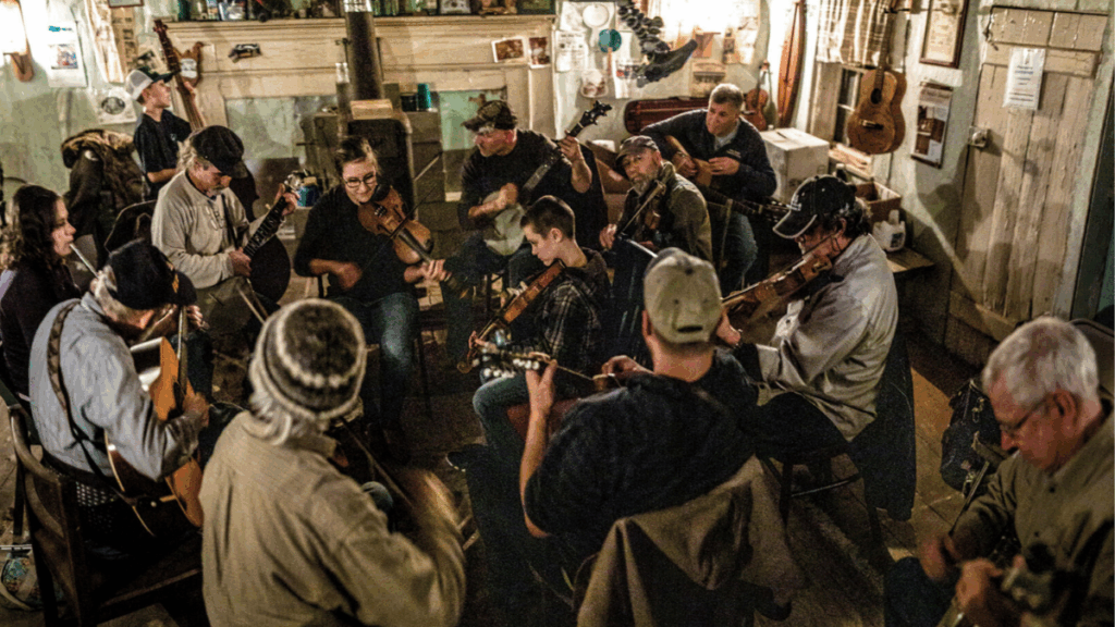 A room of people playing instruments.