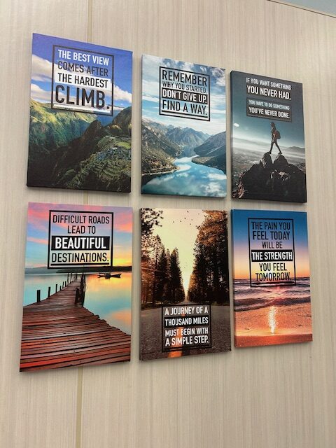 Six inspirational posters are shown on a wall.