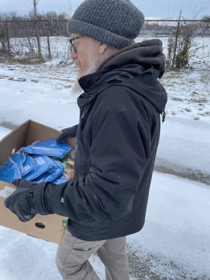 Man carries box in the snow