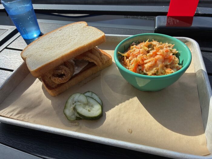 A sandwich and a bowl of coleslaw. 