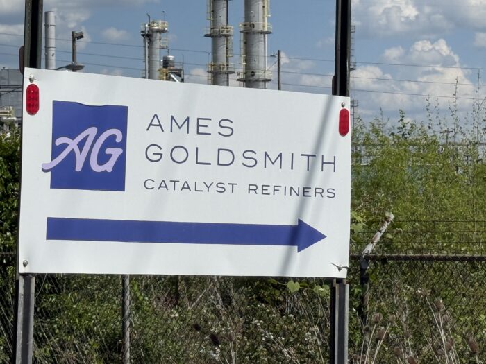 A closeup photo of a sign that reads, "Ames Goldsmith Catalyst Refiners."