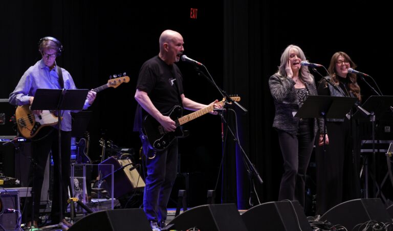 three-piece band plays music
