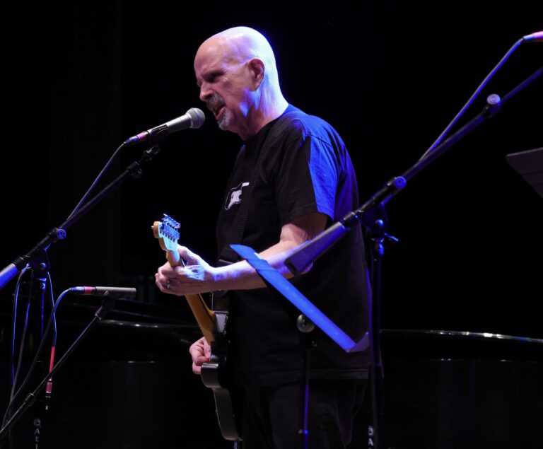 man plays guitar