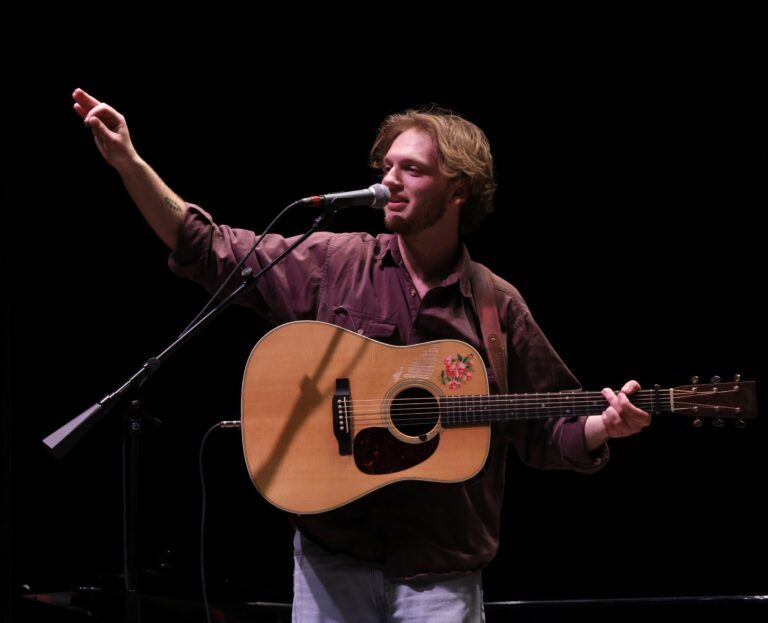 a guy plays a guitar